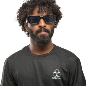 Portrait of a man in black t-shirt with stylish sunglasses and curly hair.